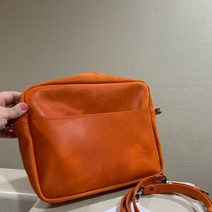 Orange leather messenger bag
